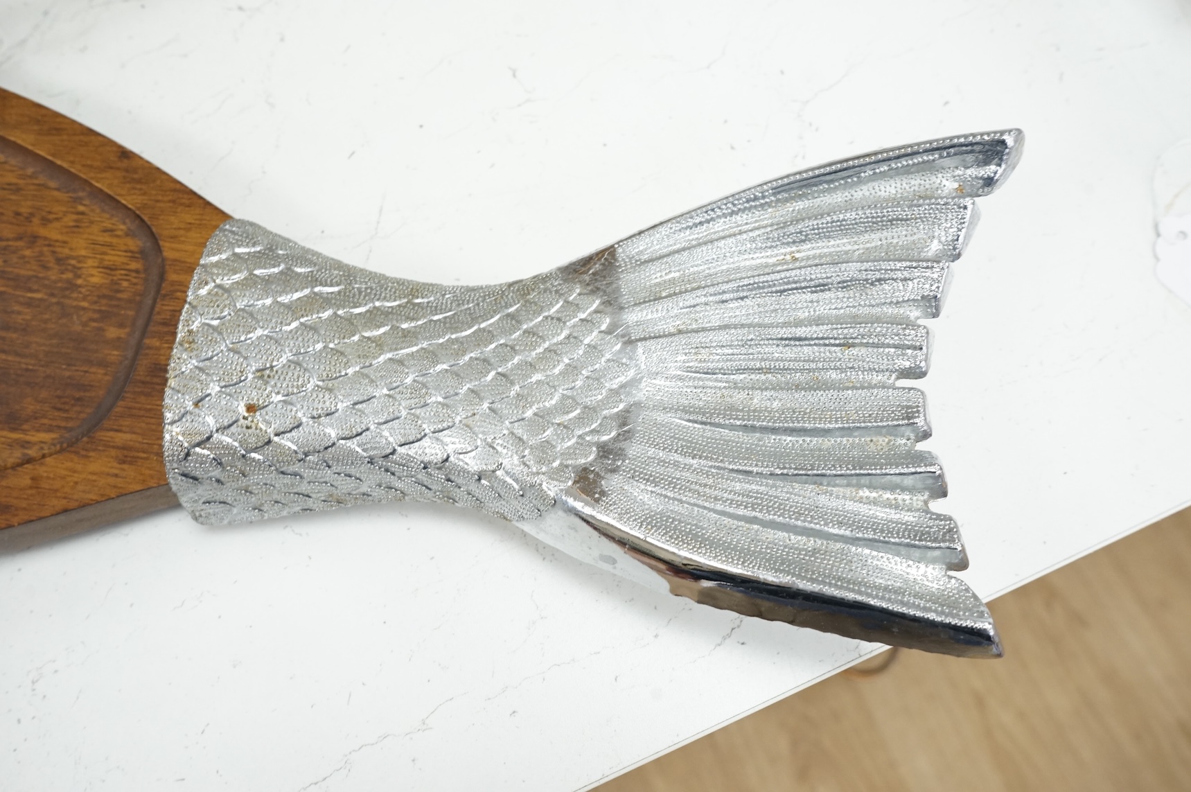 A wooden 'Fish' serving platter with plated mounts and a pair of servers, platter 87cm long